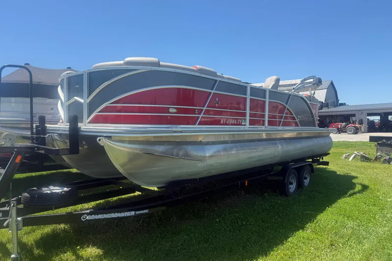 Slide: The Image of 2019 Berkshire 23RFX STS pontoon boat on trailer, parked on grass under clear blue sky. - 4