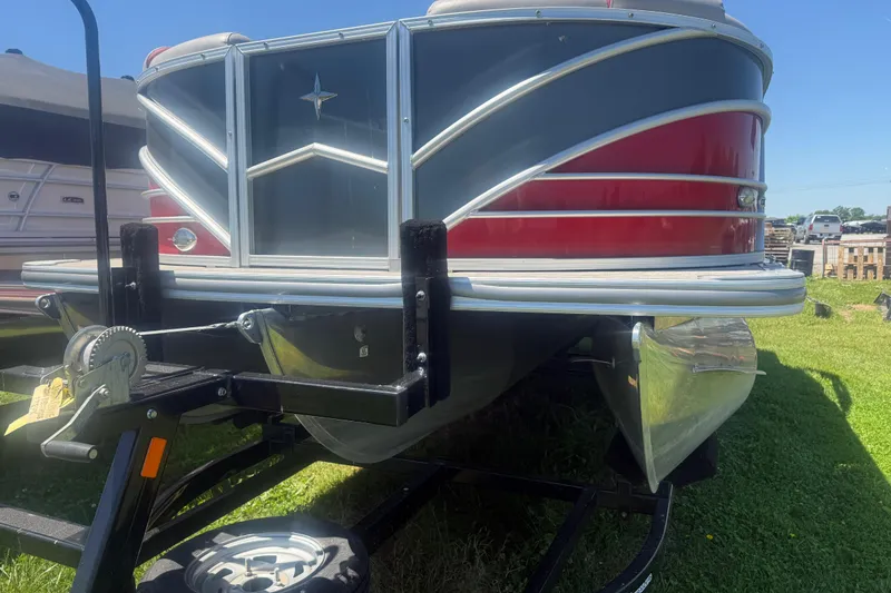 Slide: The Image of 2019 Berkshire 23RFX STS pontoon boat on trailer, featuring sleek red and silver design. - 5