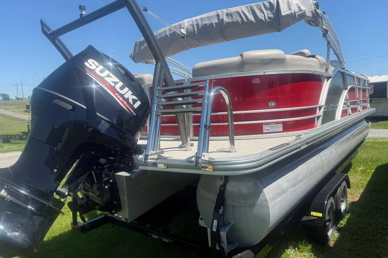 Slide: The Image of 2019 Berkshire 23RFX STS pontoon boat with Suzuki outboard motor, parked on a trailer. - 6