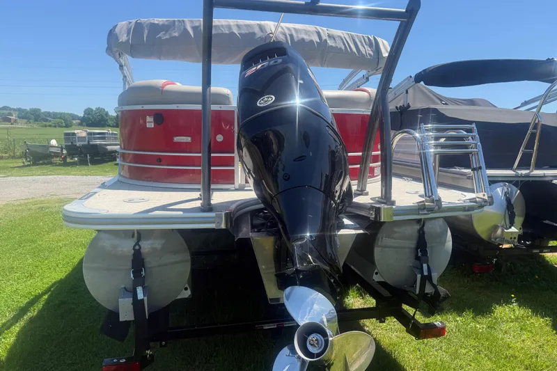 Slide: The Image of 2019 Berkshire 23RFX STS pontoon boat with outboard motor, parked on grass. - 7
