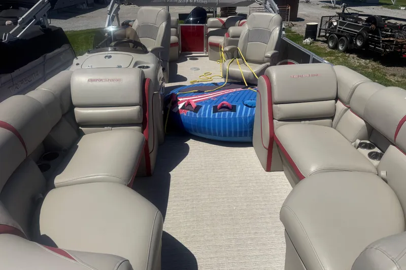 Slide: The Image of 2019 Berkshire 23RFX STS pontoon boat interior with beige seating and inflatable water toy. - 9