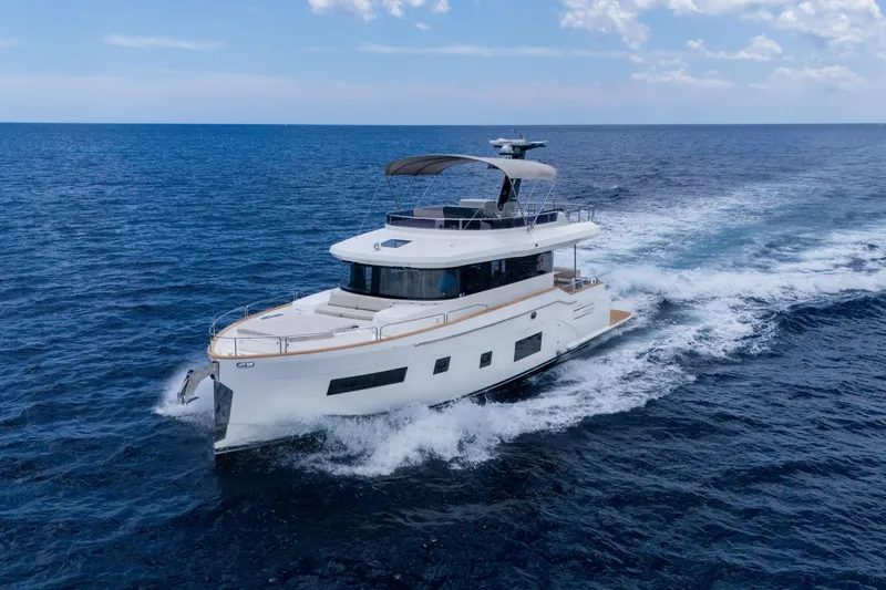 The Image of 2025 Sirena 58 yacht cruising on open sea under clear blue sky. - 0