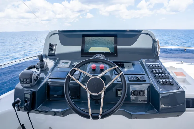 Slide: The Image of Cockpit of 2025 Sirena 58 yacht with advanced navigation controls and ocean view. - 19