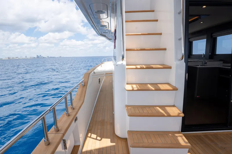 Slide: The Image of Luxurious Sirena 58 yacht deck with wooden stairs, ocean view, and modern interior, 2025 model. - 21