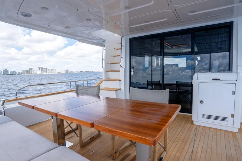 Slide: The Image of Luxury yacht Sirena 58, 2025 model, featuring elegant outdoor dining area with ocean view. - 24