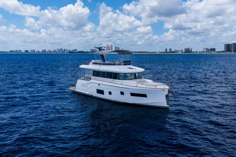 Slide: The Image of Luxurious 2025 Sirena 58 yacht cruising on open blue waters under a partly cloudy sky. - 3