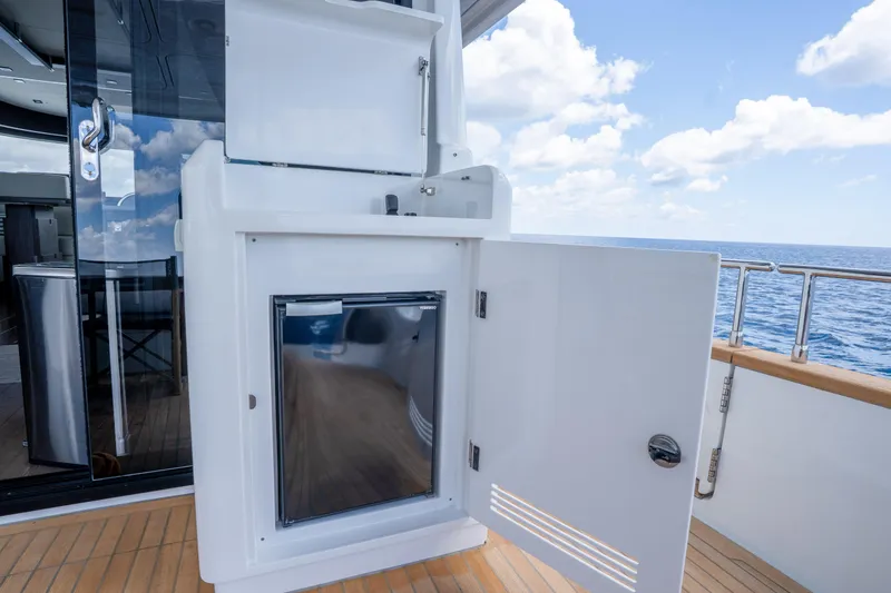 Slide: The Image of Outdoor kitchenette on 2025 Sirena 58 yacht with ocean view and open storage. - 30
