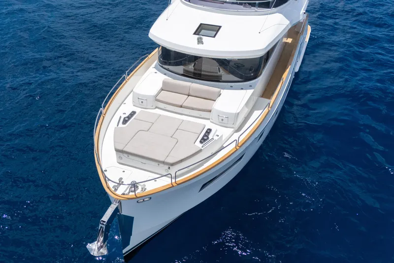Slide: The Image of Luxury Sirena 58 yacht (2025) cruising on clear blue ocean waters. - 4