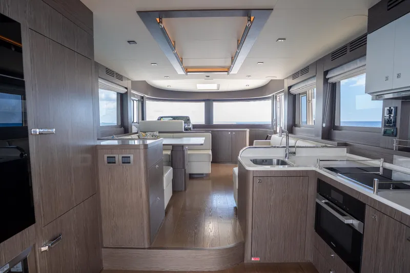 Slide: The Image of Luxurious interior of 2025 Sirena 58 yacht with modern kitchen and seating area. - 40