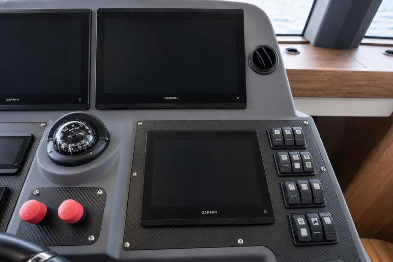 Slide: The Image of Control panel of 2025 Sirena 58 yacht with Garmin displays and compass. - 52