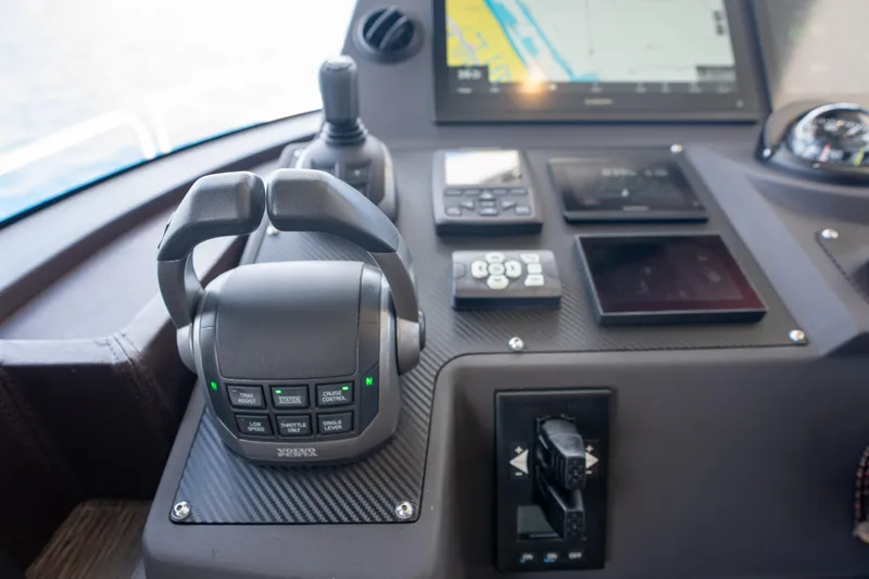 Slide: The Image of Control panel of 2025 Sirena 58 yacht with navigation and throttle controls. - 54