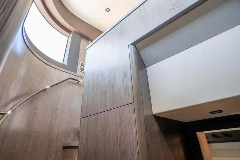 Slide: The Image of Interior view of 2025 Sirena 58 yacht, featuring modern wood paneling and sleek design elements. - 58
