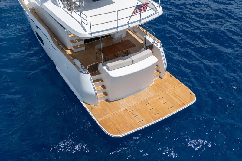 Slide: The Image of Aerial view of 2025 Sirena 58 yacht's elegant wooden deck on blue ocean. - 6