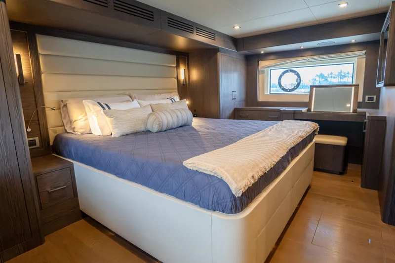 Slide: The Image of Luxurious bedroom interior of 2025 Sirena 58 yacht with elegant furnishings and large window view. - 60