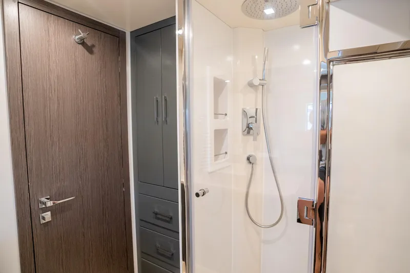 Slide: The Image of Modern bathroom interior on 2025 Sirena 58 yacht, featuring sleek shower and wooden door. - 64