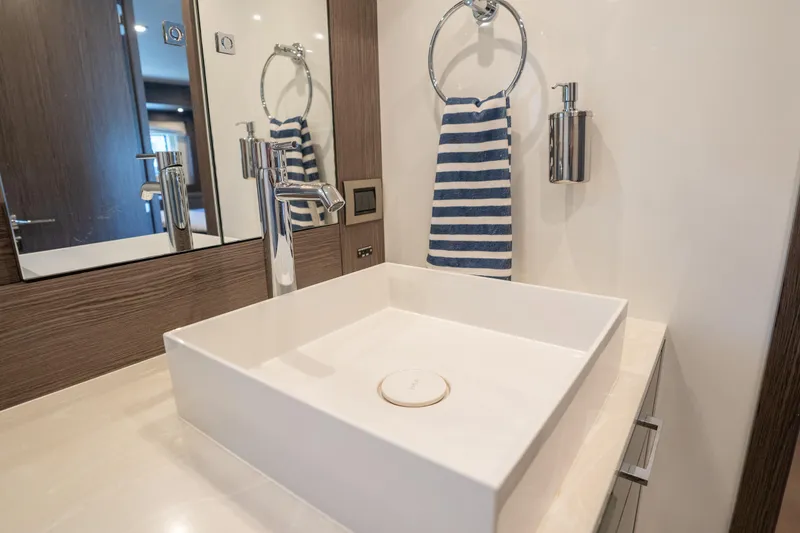 Slide: The Image of Modern bathroom sink with striped towel on Sirena 58 yacht, 2025 model. - 66