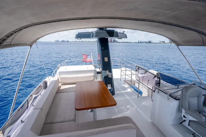 Slide: The Image of Luxurious 2025 Sirena 58 yacht deck with seating, table, and ocean view. - 7