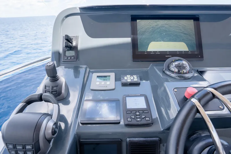 Slide: The Image of Helm of 2025 Sirena 58 yacht with navigation controls and display screens. - 73