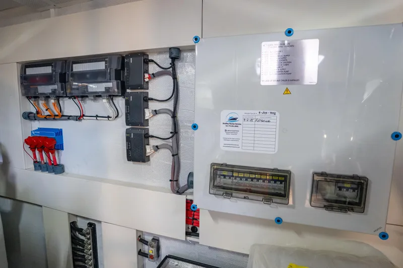 Slide: The Image of Electrical panel inside a 2025 Sirena 58 yacht, showcasing wiring and circuit components. - 86