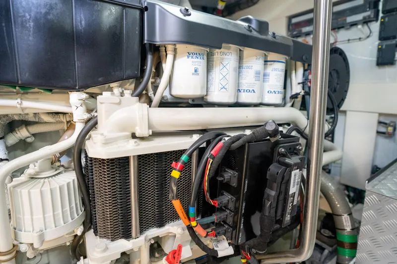 Slide: The Image of Engine compartment of 2025 Sirena 58 yacht, featuring Volvo Penta components and wiring. - 87