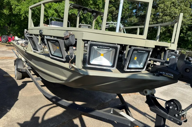 Slide: The Image of 2020 Tracker Grizzly 1860 CC Sportsman boat with mounted lights on a trailer. - 14