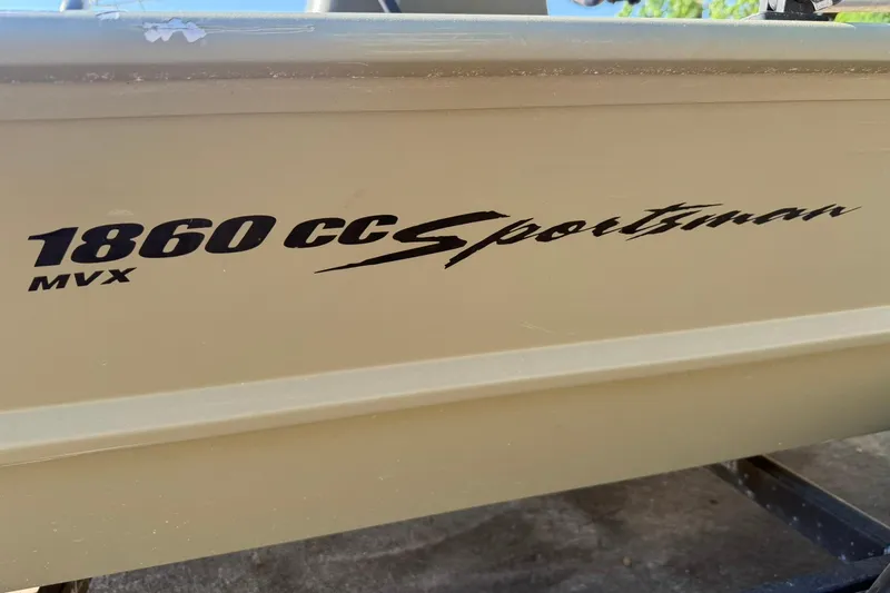 Slide: The Image of 2020 Tracker Grizzly 1860 CC Sportsman boat side view with model branding. - 15
