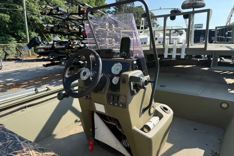 Slide: The Image of 2020 Tracker Grizzly 1860 CC Sportsman boat interior with steering console and gauges. - 16
