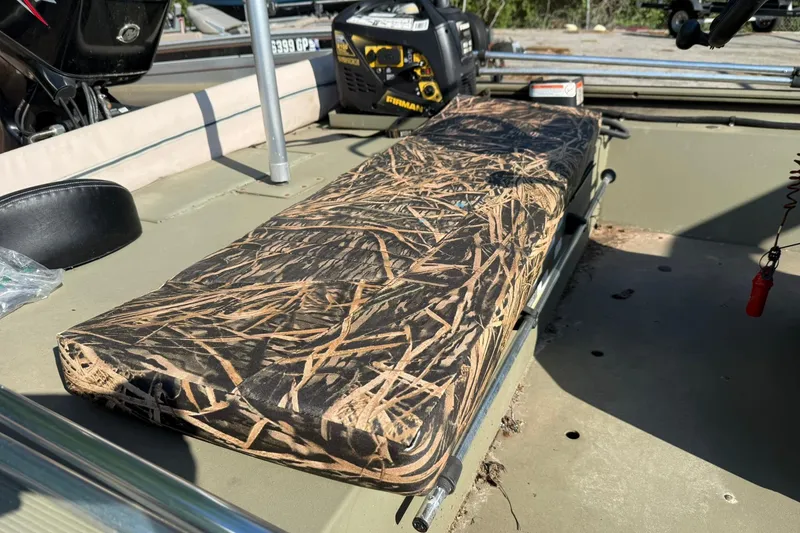 Slide: The Image of 2020 Tracker Grizzly 1860 CC Sportsman boat interior with camo seat and equipment. - 17