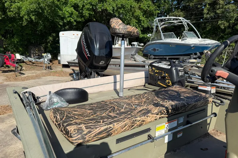 Slide: The Image of 2020 Tracker Grizzly 1860 CC Sportsman boat with camo seats and Mercury engine. - 2