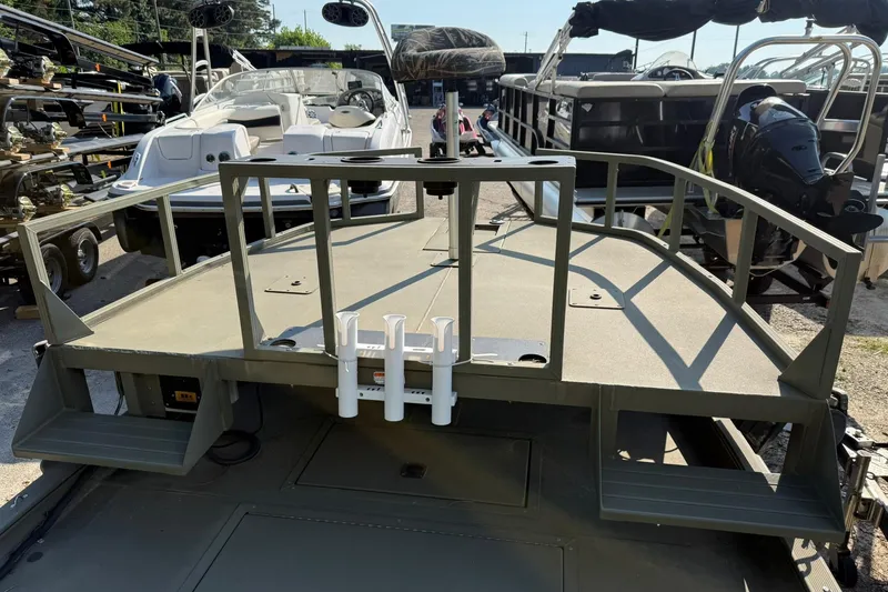 Slide: The Image of 2020 Tracker Grizzly 1860 CC Sportsman boat, docked with other vessels in a marina. - 3