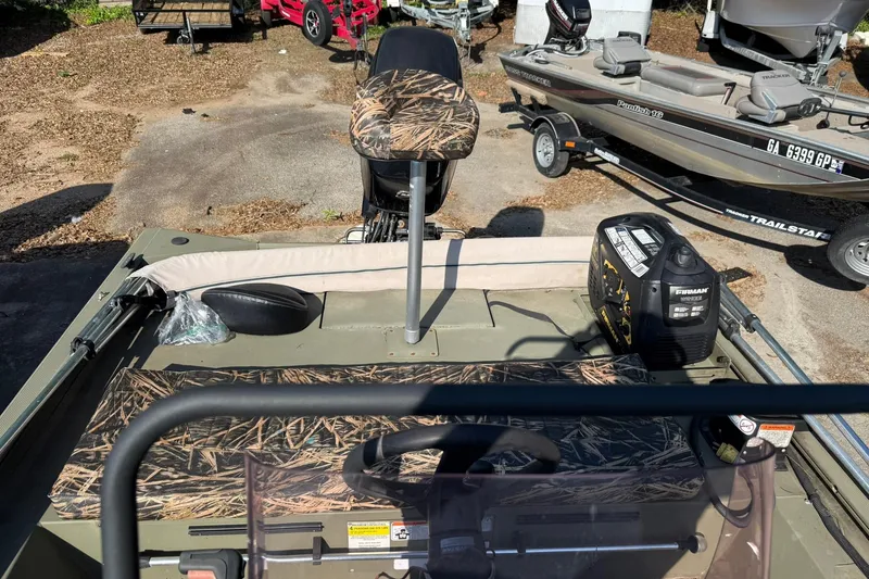 Slide: The Image of 2020 Tracker Grizzly 1860 CC Sportsman boat with camo seats and equipment on deck. - 4
