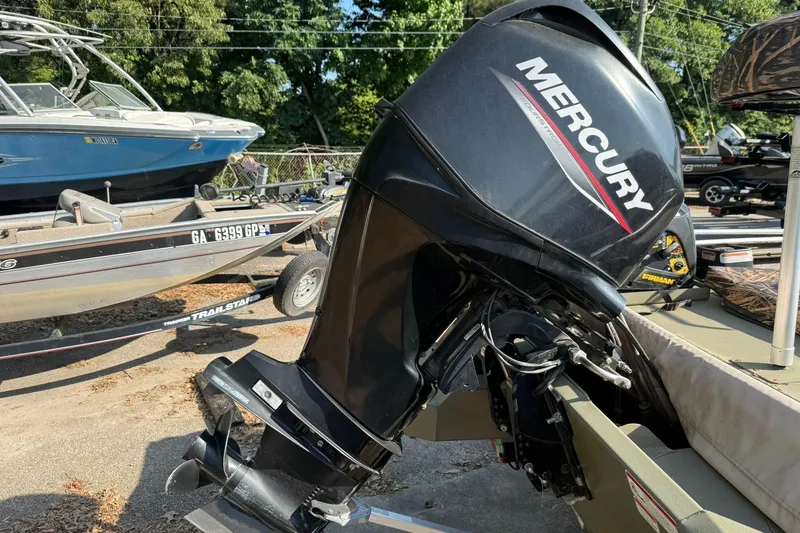 Slide: The Image of 2020 Tracker Grizzly 1860 CC Sportsman with Mercury outboard motor in a boatyard. - 6
