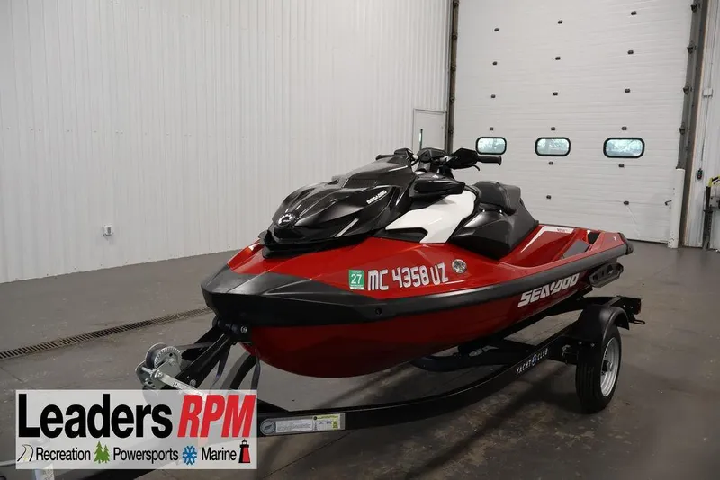 The Image of 2026 Sea-Doo RXP-X 325 jet ski on trailer in indoor showroom. - 0