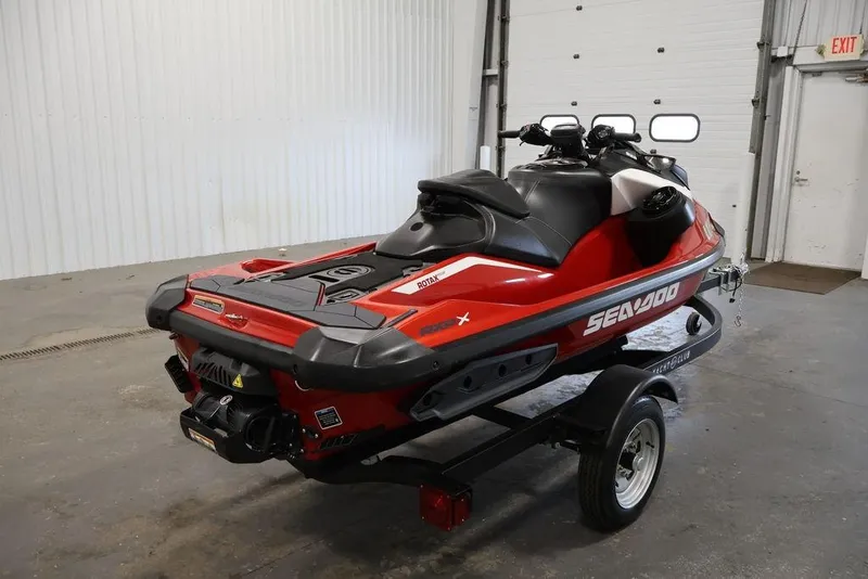 Slide: The Image of 2026 Sea-Doo RXP-X 325 jet ski in a garage, red and black design. - 1