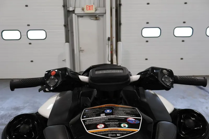Slide: The Image of 2026 Sea-Doo RXP-X 325 handlebars and controls in a garage setting. - 10