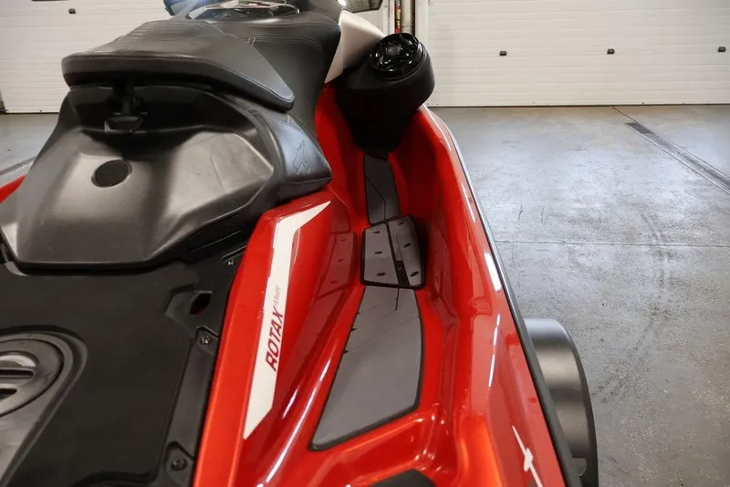 Slide: The Image of 2026 Sea-Doo RXP-X 325 jet ski, red and black design, in a garage setting. - 12