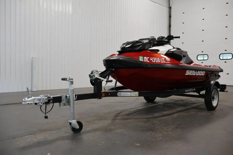 Slide: The Image of 2026 Sea-Doo RXP-X 325 jet ski on trailer in a garage setting. - 15
