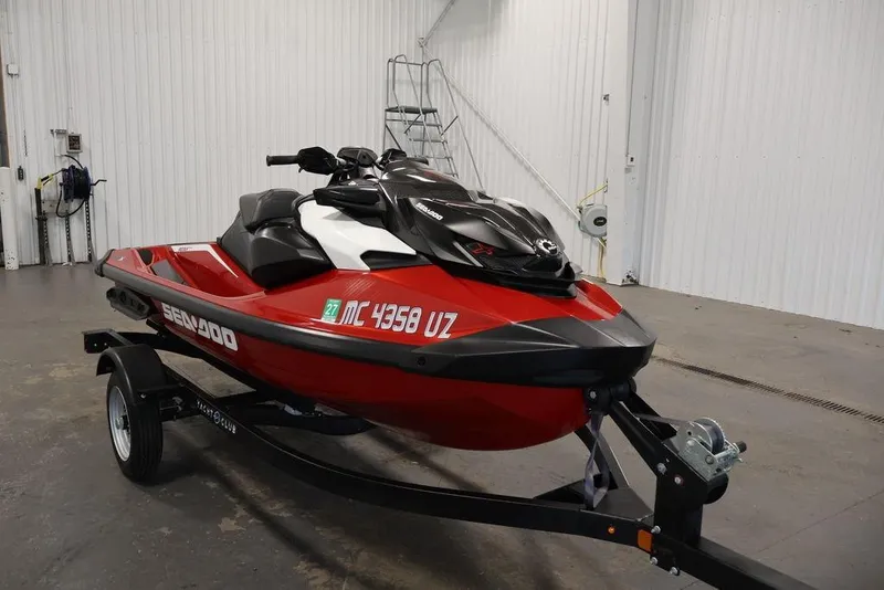 Slide: The Image of 2026 Sea-Doo RXP-X 325 jet ski in a garage, red and black design on trailer. - 3