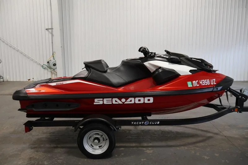 Slide: The Image of 2026 Sea-Doo RXP-X 325 jet ski in red, displayed on a trailer indoors. - 6