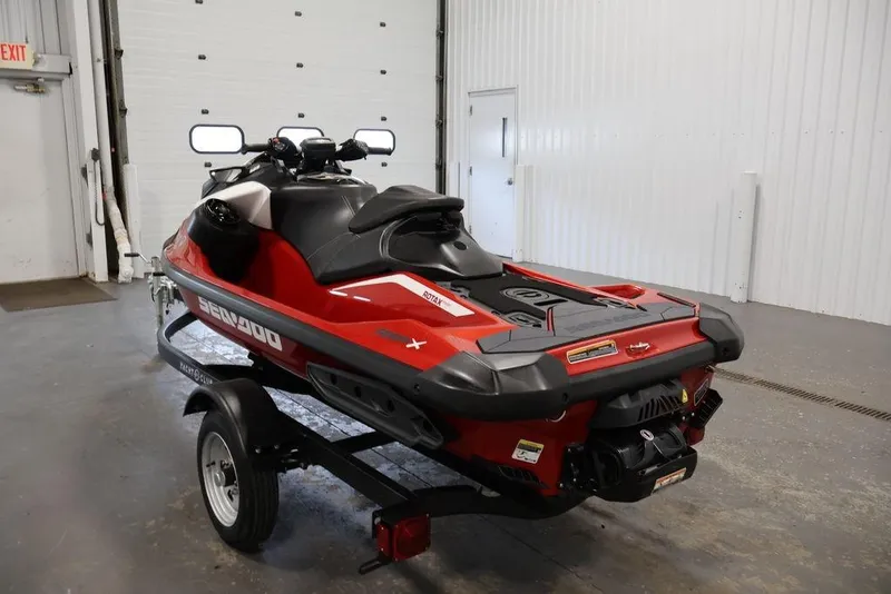 Slide: The Image of 2026 Sea-Doo RXP-X 325 jet ski in a garage, red and black design. - 7