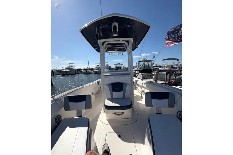 Slide: The Image of 2021 Robalo R230 Center Console boat docked at marina under clear blue sky. - 3