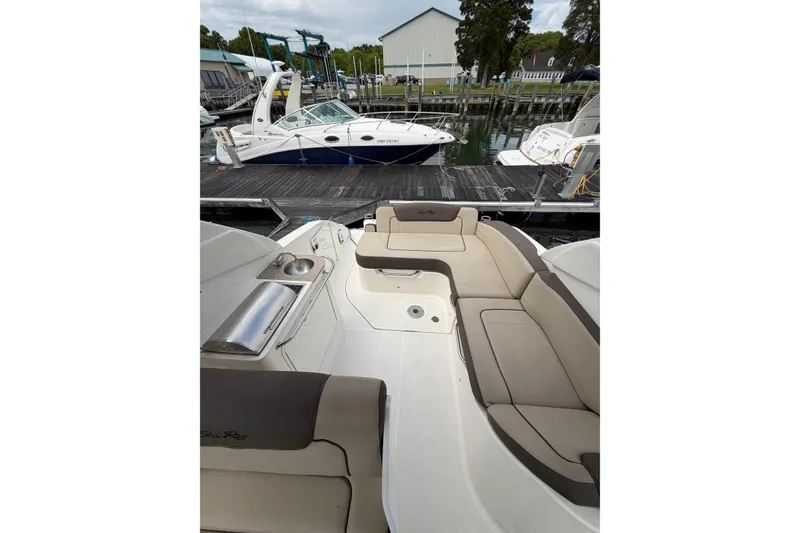 Slide: The Image of 2015 Sea Ray 280 Sunrunner boat docked, featuring spacious seating and sleek design. - 5