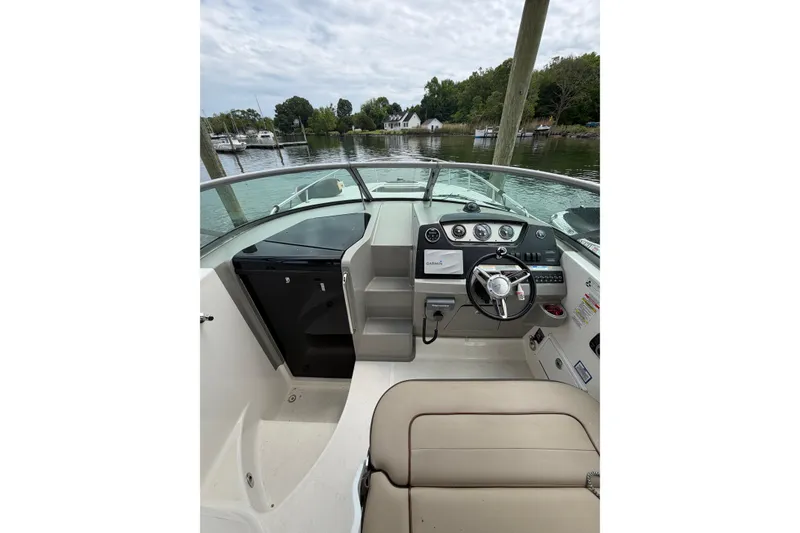 Slide: The Image of 2015 Sea Ray 280 Sunrunner boat cockpit with steering wheel and control panel. - 8