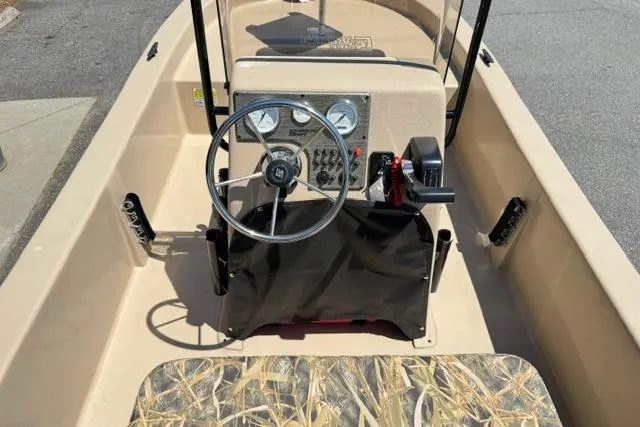 Slide: The Image of 2026 Carolina Skiff E18 JVX CC boat interior with steering wheel and control panel. - 10