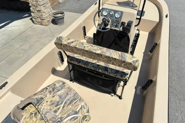 Slide: The Image of 2026 Carolina Skiff E18 JVX CC boat interior with camouflage seating and steering console. - 11