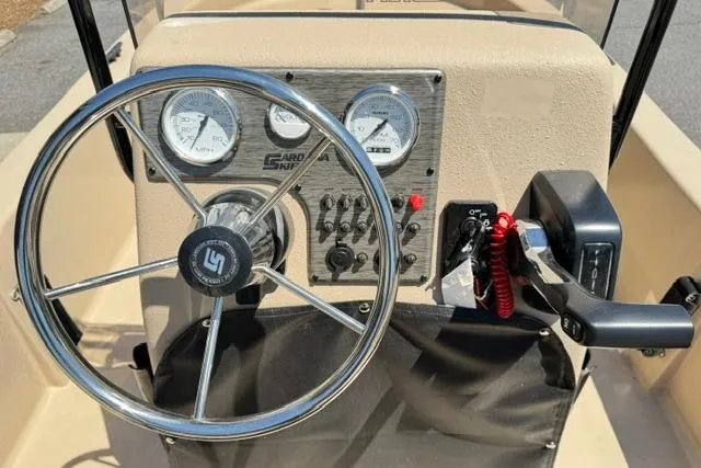 Slide: The Image of 2026 Carolina Skiff E18 JVX CC boat dashboard with steering wheel and control panel. - 12