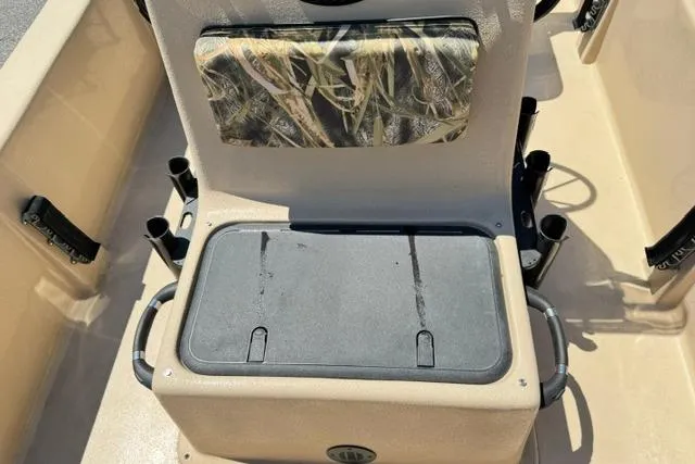 Slide: The Image of 2026 Carolina Skiff E18 JVX CC boat interior with camouflage seat and storage compartment. - 13