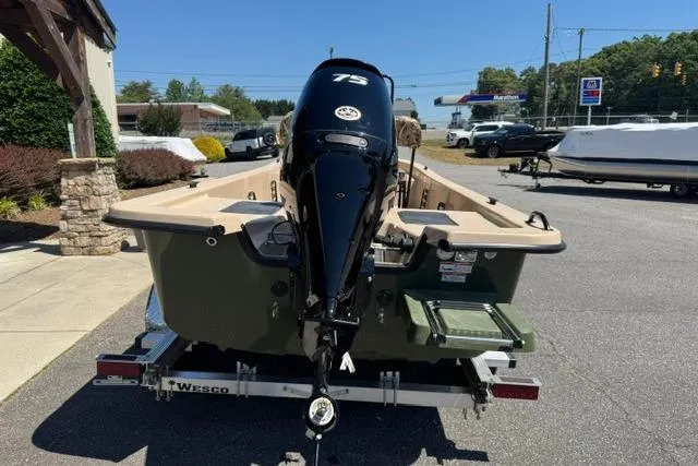 Slide: The Image of 2026 Carolina Skiff E18 JVX CC boat on trailer, featuring a 75 HP outboard motor. - 6