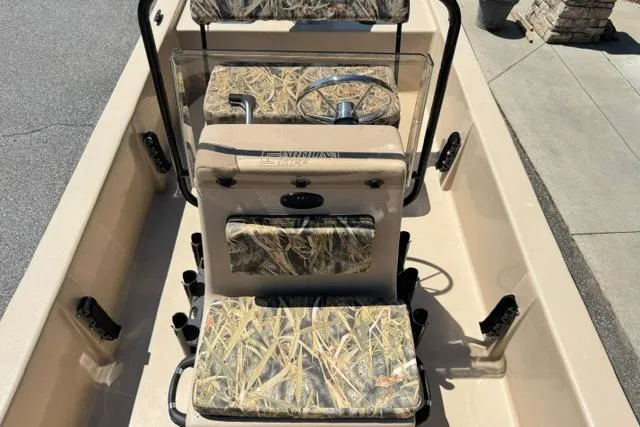 Slide: The Image of 2026 Carolina Skiff E18 JVX CC boat interior with camouflage seating and steering console. - 8