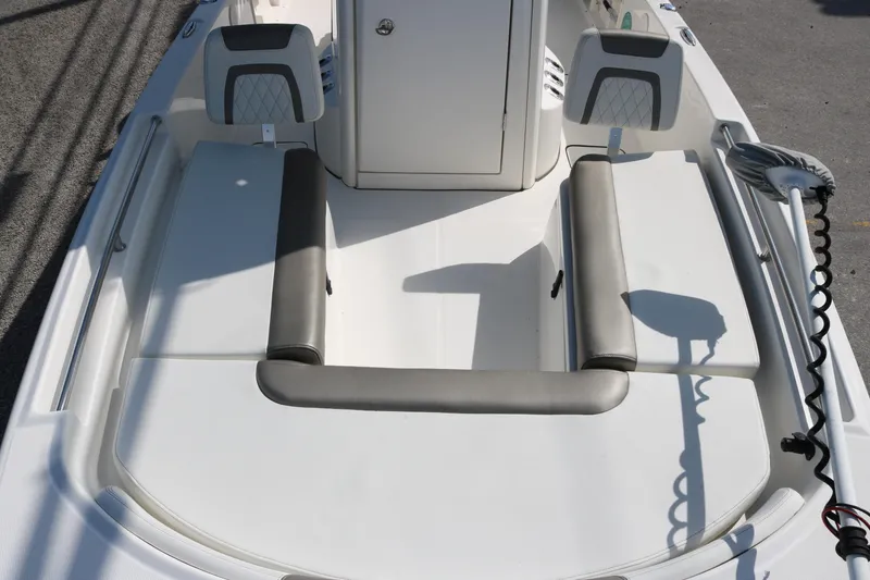 Slide: The Image of 2023 World Cat 235 CC boat interior with cushioned seating and storage compartments. - 11